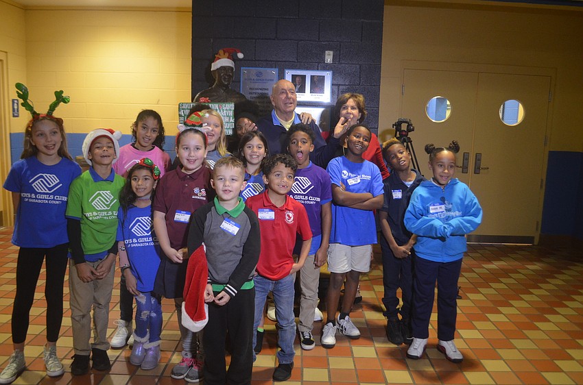 Dick Vitale and Lorraine Vitale pose with a group of kids from the Boys and Girl's Club.