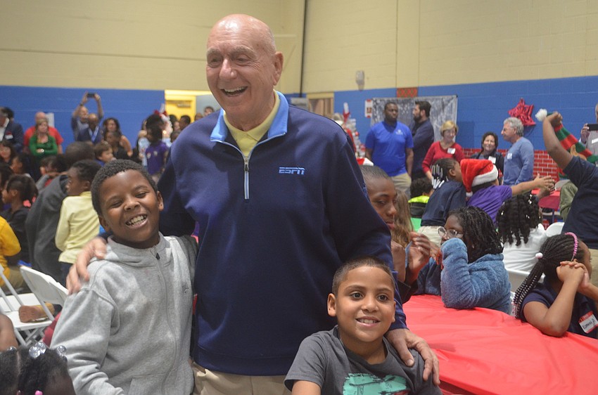 Damon Dipina and Christopher Guitard get a hug from Dick Vitale.