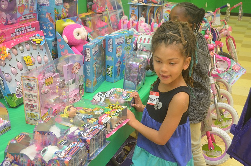 Trelayja Thomas peruses the gifts given out to the Boys and Girl's Club.