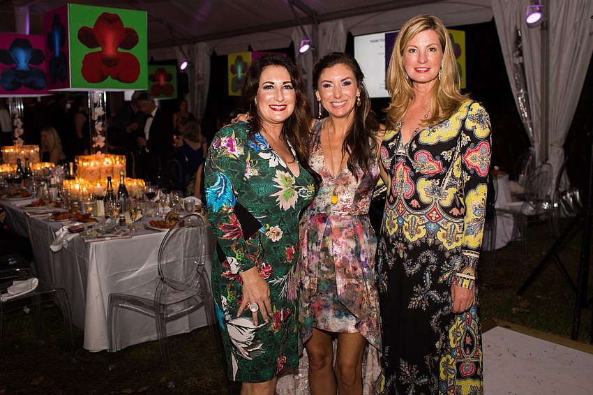 Terri Najmolhoda, Donna Koffman and Brenda Michel dressed in colorful floral prints for Orchid Ball Feb. 10 at Marie Selby Botanical Gardens.