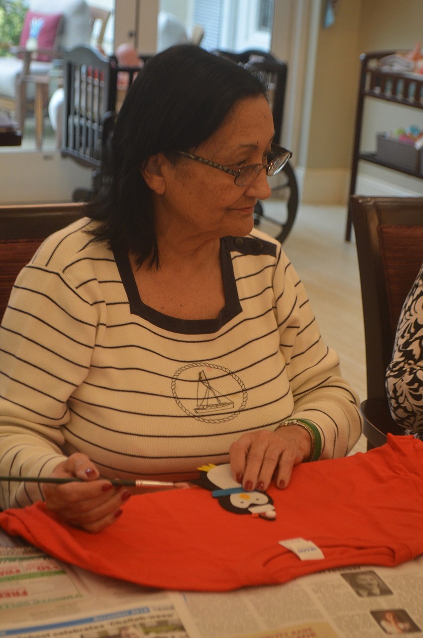 Renie Hale uses two snowmen to decorate her sweater.