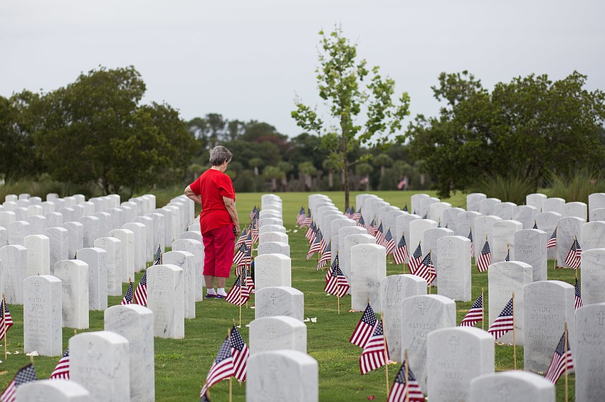Through the drizzle of a late-May morning, hundreds paid Memorial Day respects at the Sarasota National Cemetery.