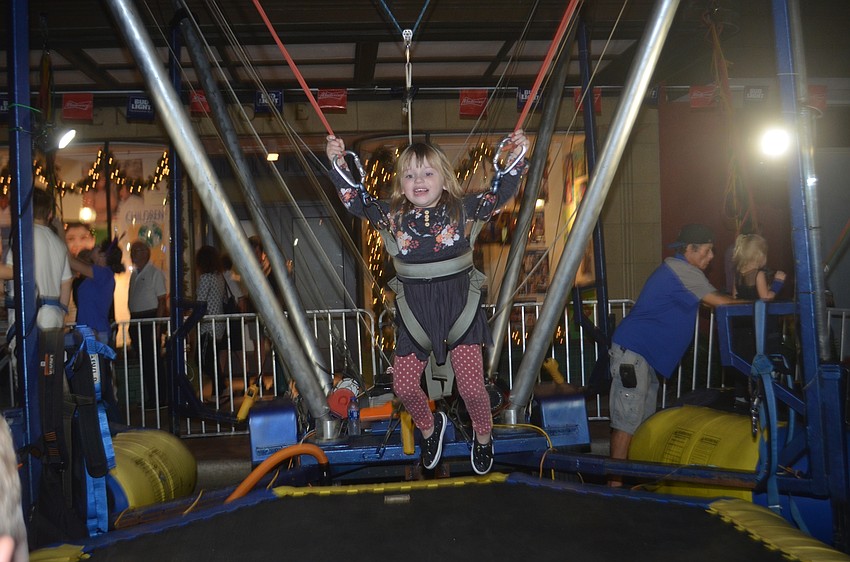 Madison Henke takes a ride in the trampoline swing.