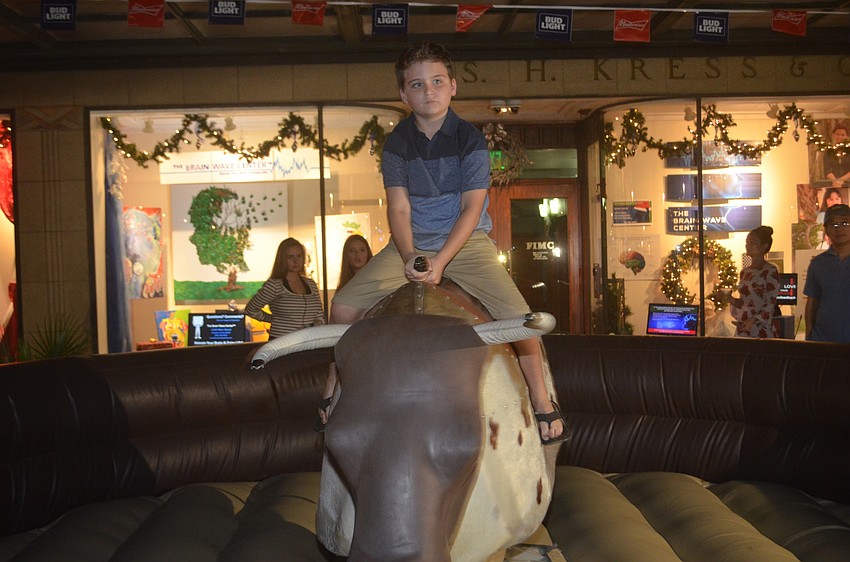 Randall Ursy rides the mechanical bull.