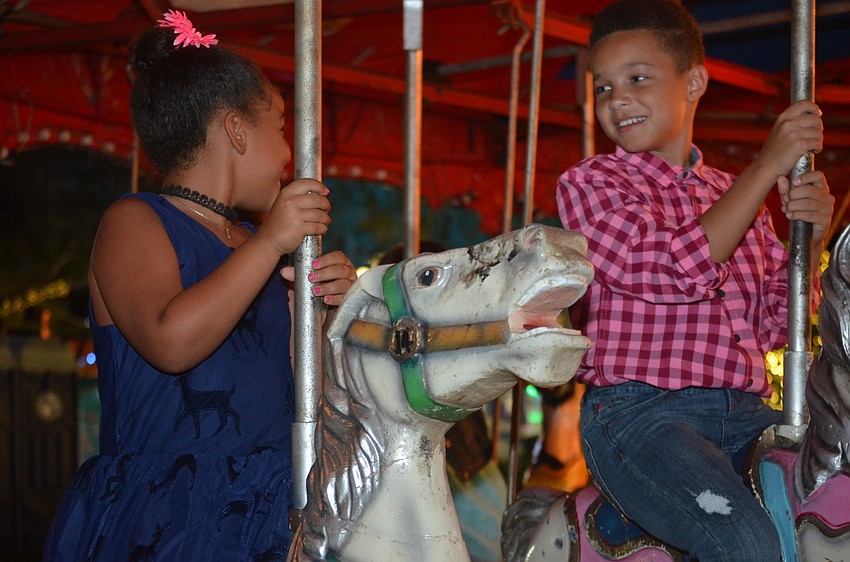 Nala Wingate and Kyan Wingate ride the merry-go-round.
