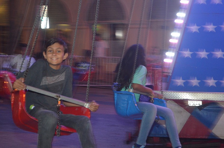 Garen Naidoo flashes a smile while he goes around on the swing.
