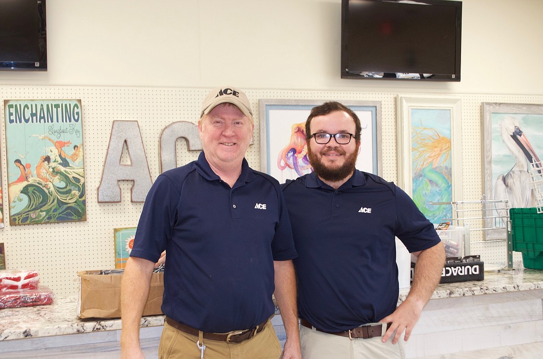 Jimmy Stonecypher, store manager, and owner, Charles Savidge, stand in the store&#39;s new space.