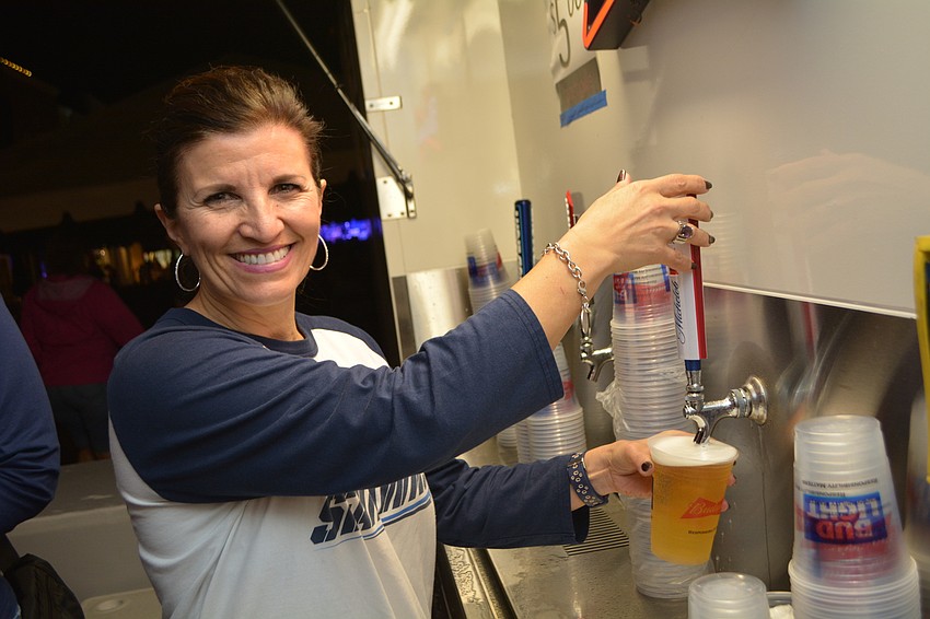 Lakewood Ranch's Violeta Huesman pours beer for the Lakewood Ranch Community Fund, the night's benefiting charity.