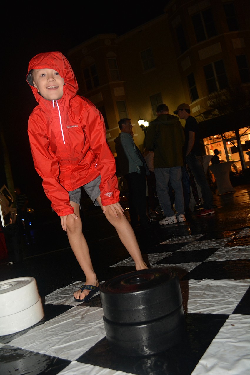 Parrish resident Jacob Farrington, 7, plays his father, Scott, in a game of life-sized checkers.
