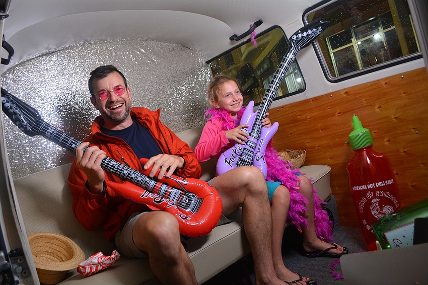 Lakewood Ranch's Jeff Muchmore and his soon-to-be step-daughter Gabriella Garner, 7, pose for a photo booth during the celebration.