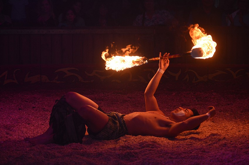 Seanoa Lavata thrills the crowd as he juggles fire.