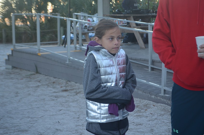 Maeve Murray huddles up in the early morning cold.