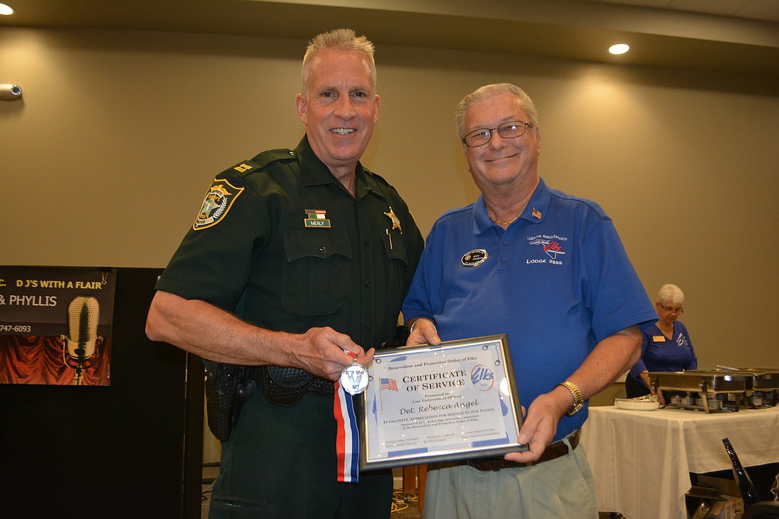 Capt. Robert Mealy accepts an award for Det. Rebecca Angel, who couldn&#39;t be in attendance and who was being honored by the Lakewood Ranch Elks during Law Enforcement Appreciation Night.