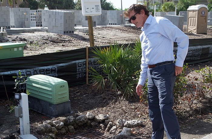 Dave Bishop shows how high water has been on Buttonwood Drive.