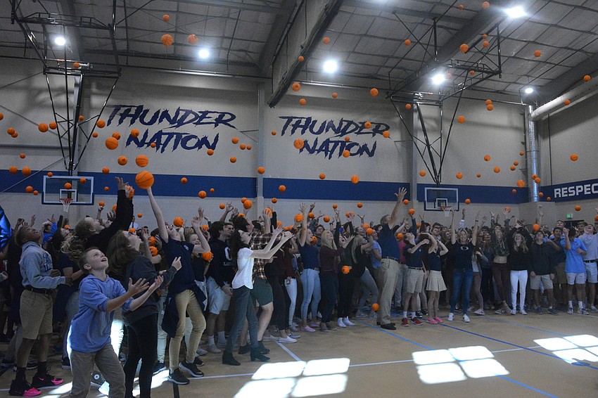 The ODA crowd throws commemorative mini-basketballs in the air at the close of the school's ceremony at its new field house.