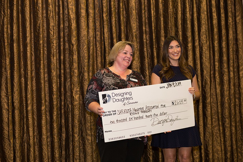 Executive Director Brandi Ezell collected the check for Sarasota Manatee Association for Riding Therapy.