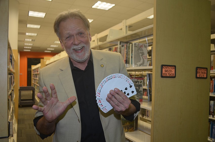 Magician David Pitchford shows off some card tricks.