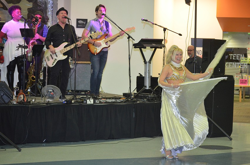 Reverend Barry and the Funk Band play while Delightful Dee dances for the crowd.