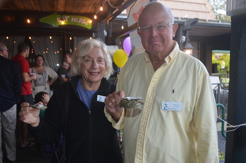 Marcy Kaiser and Warren Kaiser sample some oysters.