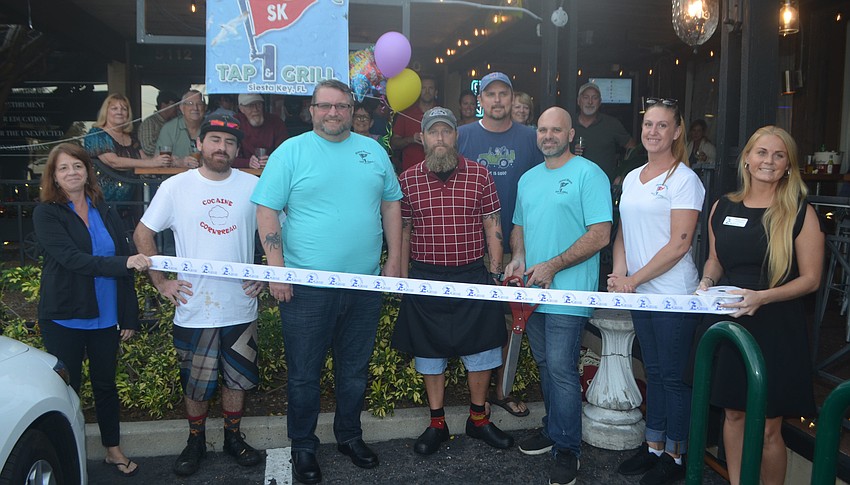 Siesta Key Chamber of Commerce's Mia Leone and  Rachel Dixon (far right) with Island House Tap and Grill's James Ridout, Robby Clark, Tony Hawkins, Troy Jenkins and Emily Leighton