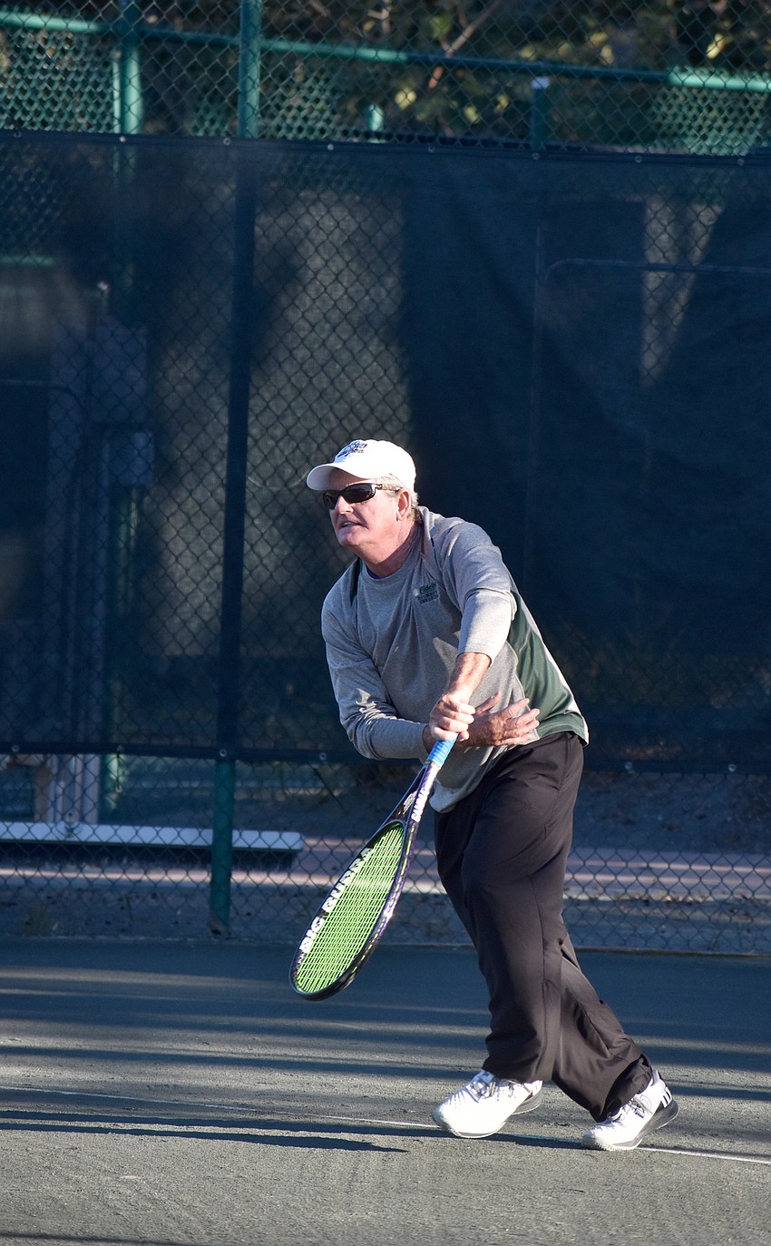 Warren Girle serves the ball during the exhibition match.