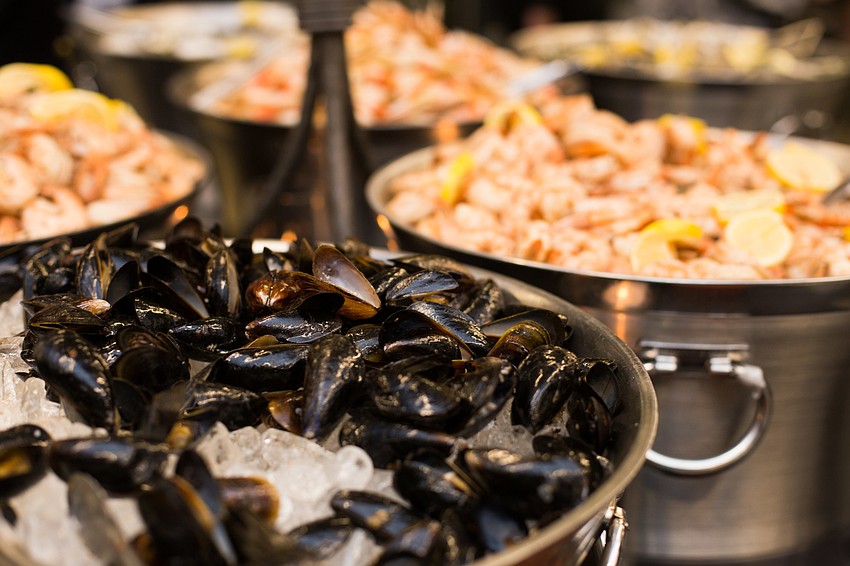 A seafood table offered options such as shrimp, clams and oysters.