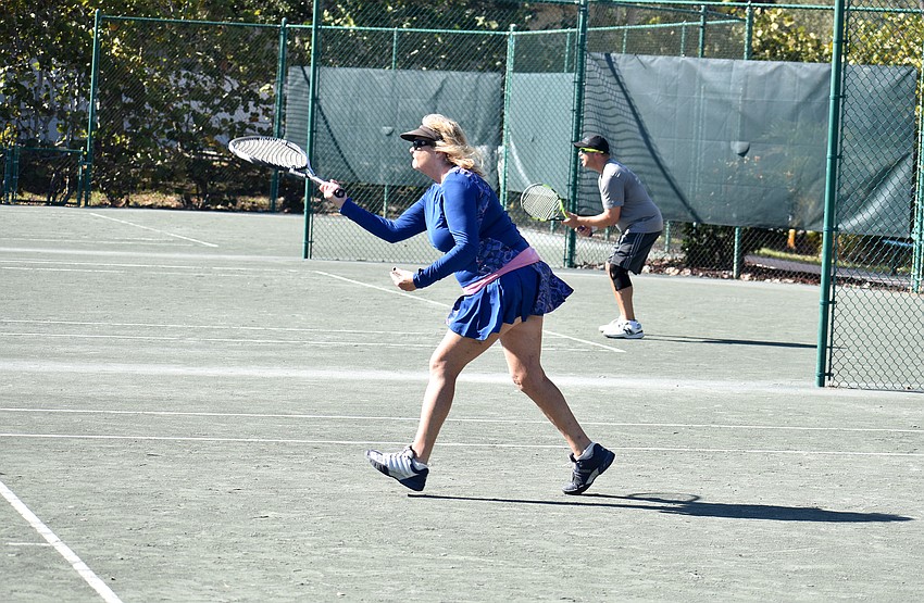 Bernadette Hayes returns the ball during a mixed doubles match.
