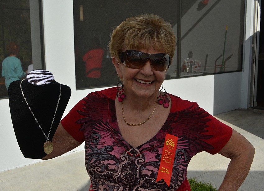 Elks member Anita Wozniak shows off a necklace that was being raffled.