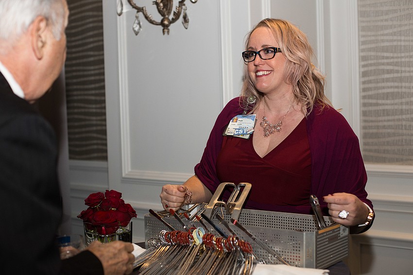 Angie Turner tells a guest about the instrumentation used in the cardiac and ICU care.