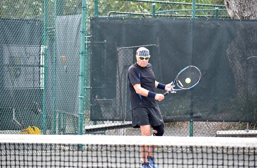 John Beeman returns the ball during a final match.