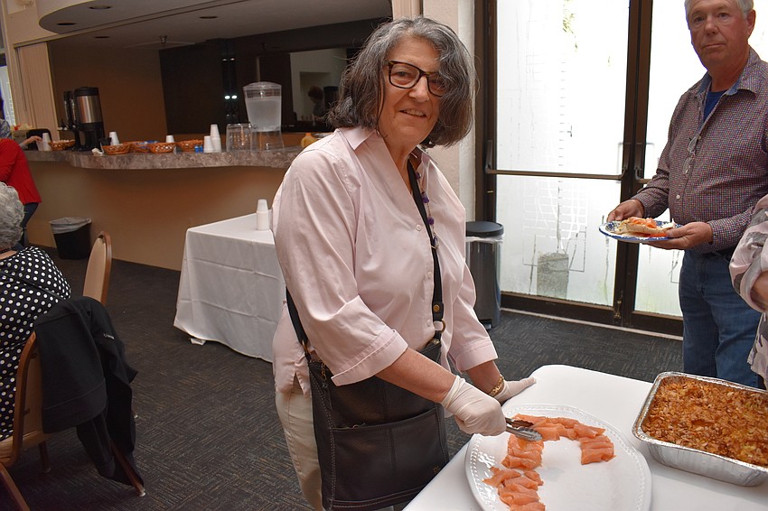 Esme Faerber serves toppings for the bagels.