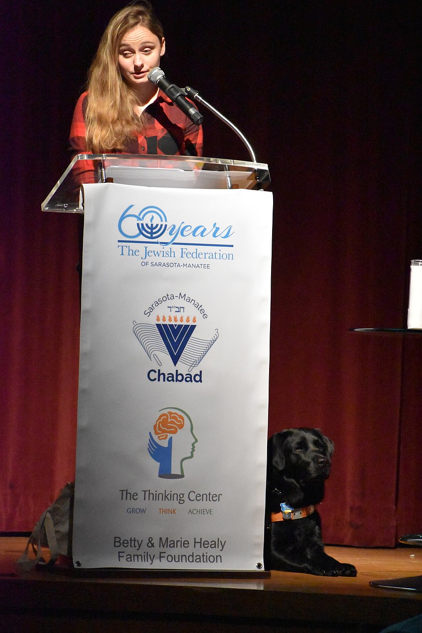 Taylor Muske is one of the speakers at the event, with her service dog at her side.