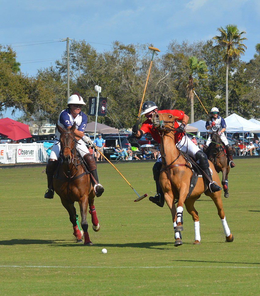The Internationals' Paul Wadsworth tries to prevent Wrigley Media's James Miller from getting off a shot at the Sarasota Polo Club Jan. 13.