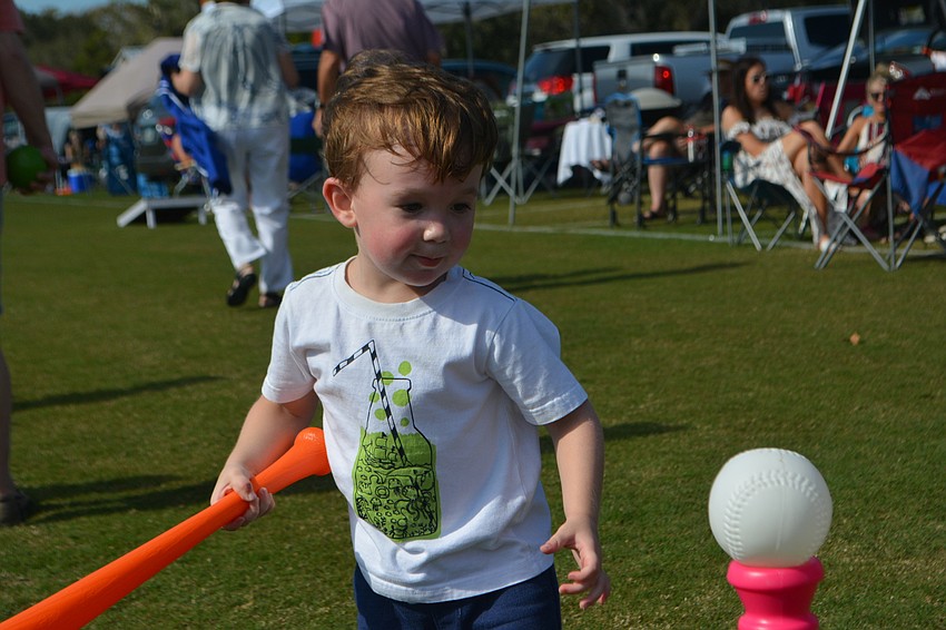 Sarasota 2-year-old Max Morand enjoys a little batting practice before the match.