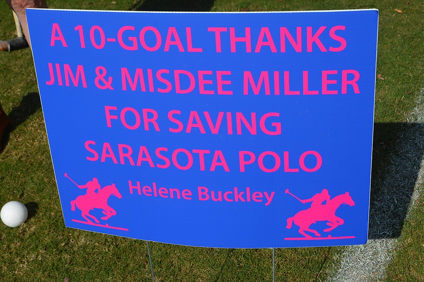 East County's Helene Buckley lets Sarasota Polo Club owners James and Misdee Miller know how she feels with a sign.