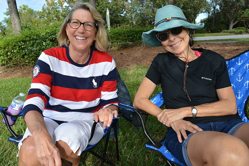 Friends Valerie Stafford-Mallis and Kathy Combs, of Lakewood Ranch, checked out information on the upcoming campout while at the concert.