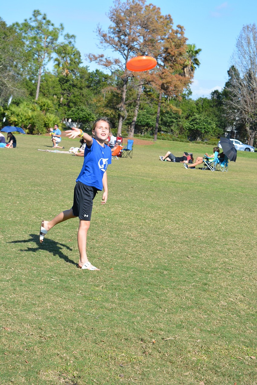Nine-year-old Abby Johnson, of River Club, plays Frisbee with her siblings, Charlie and Levi.