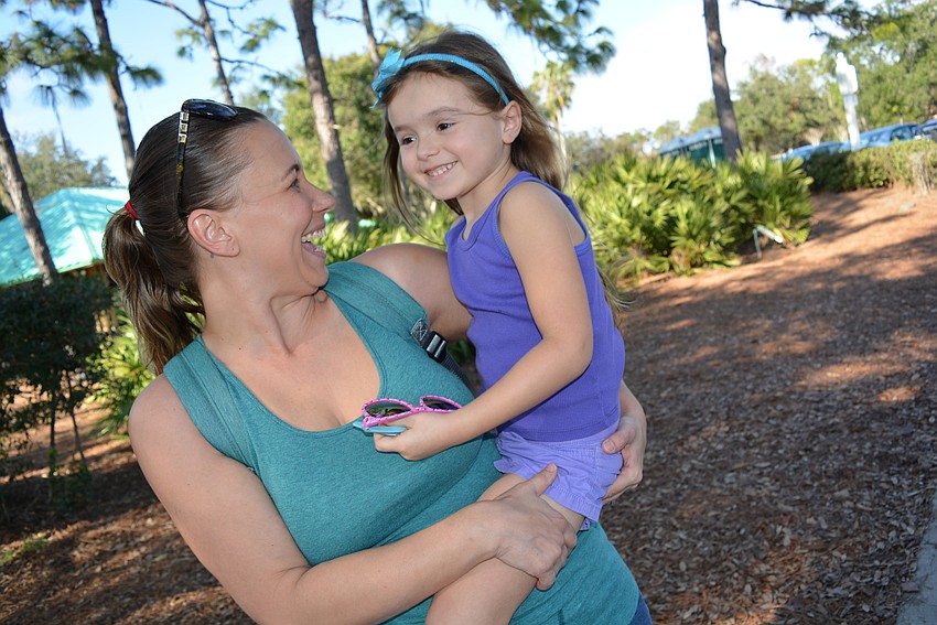 Sarasota's Jessica Reeves and her 4-year-old daughter Elena dance in the shade.