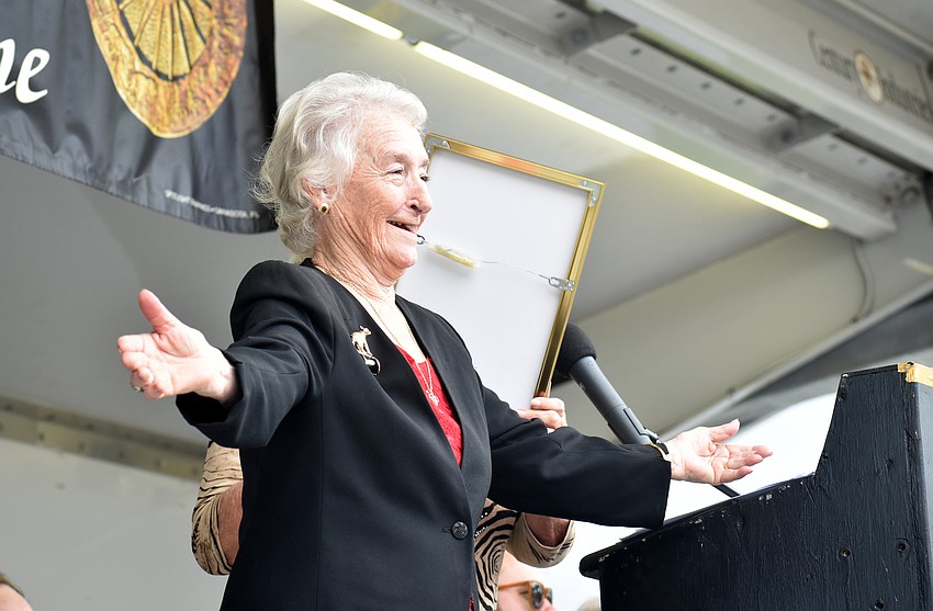 Lisa Hernandez smiles for the crowd as she accepts the plaque for The Hernandez Troupe.