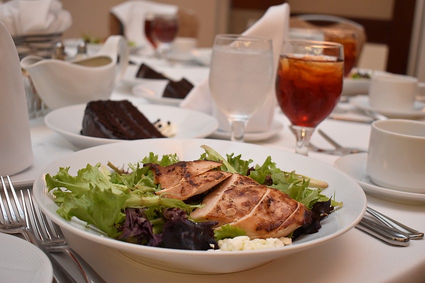 Attendees were served salad with chicken, as well as tea and chocolate cake.