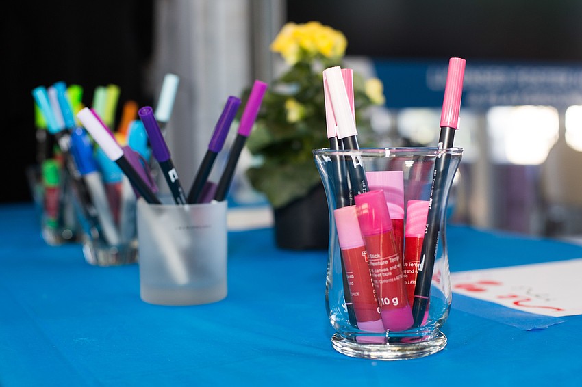 Pens in all the colors of the rainbow were set out to sign the wall.