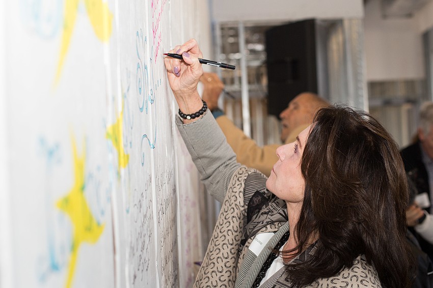 Elaine Crouse writes her message on the wall.
