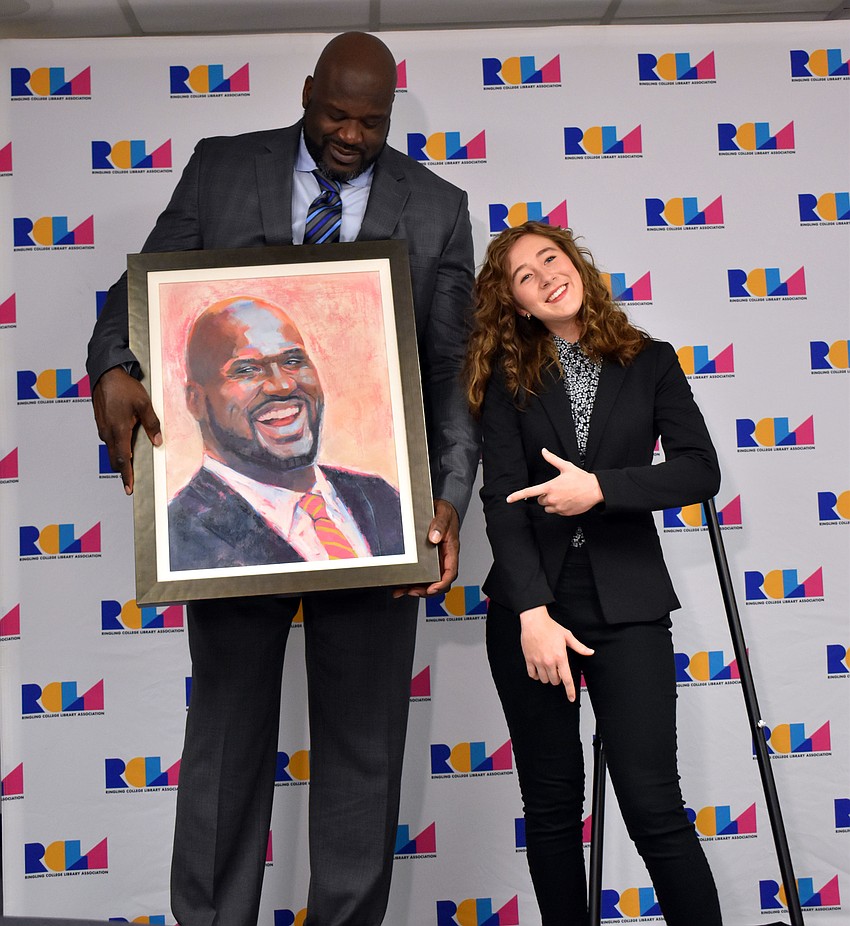 Ringling College of Art and Design junior Jamie Green posed for a photo with Shaquille O'Neal and the oil painting she did of him before listening to him speak Jan. 16.