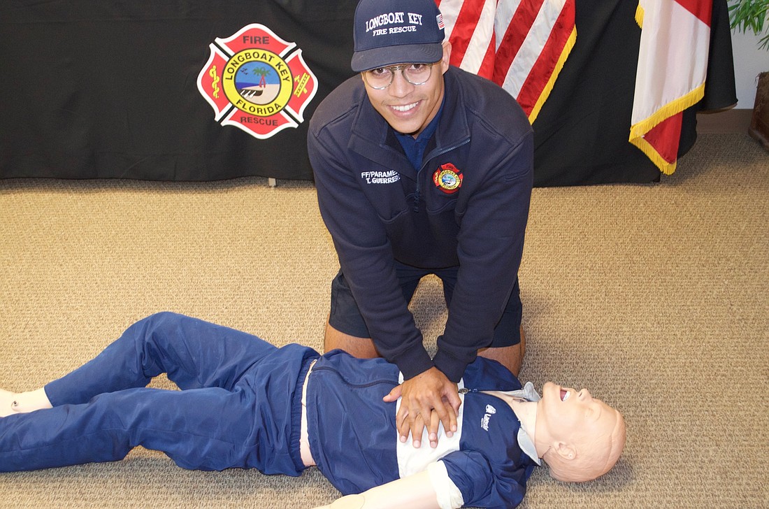 Firefighter Paramedic Tirso Guerrero demonstrates CPR.