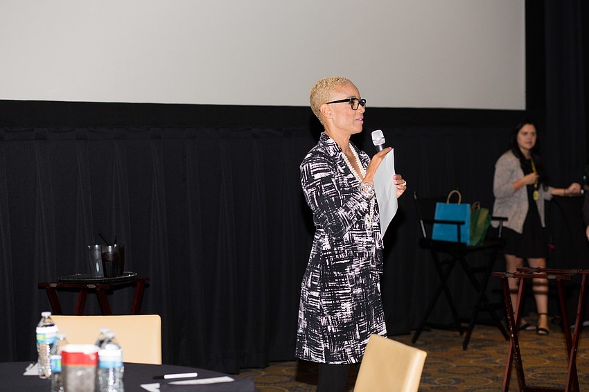 Brook Bello tells the audience about the effects of the government shutdown to local nonprofits.