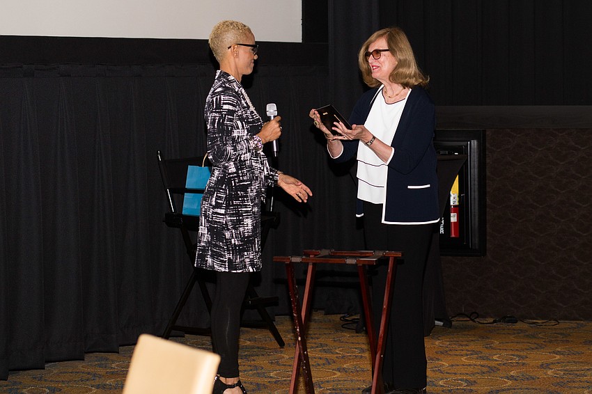 Brook Bello awards Diana Rowan Rockefeller with the Woman of the Year award.