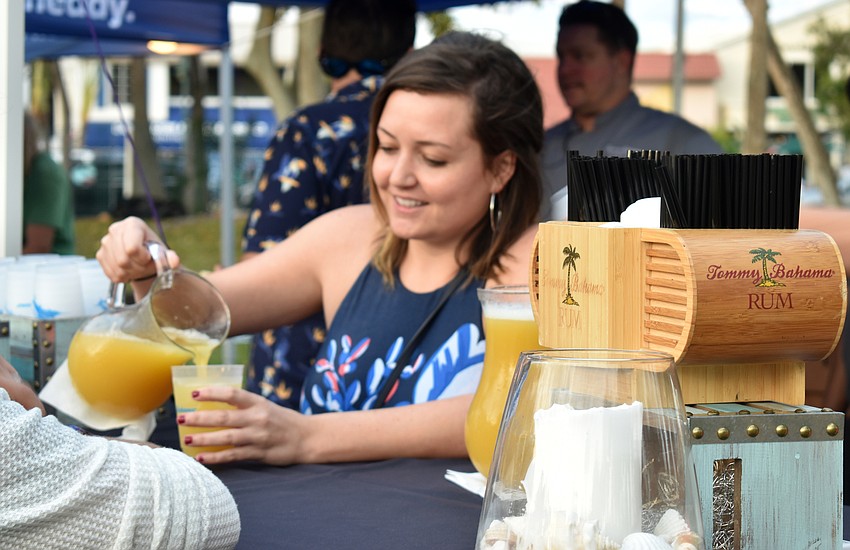 Cassie Gilmore serves drinks for Tommy Bahama Restaurant and Bar.