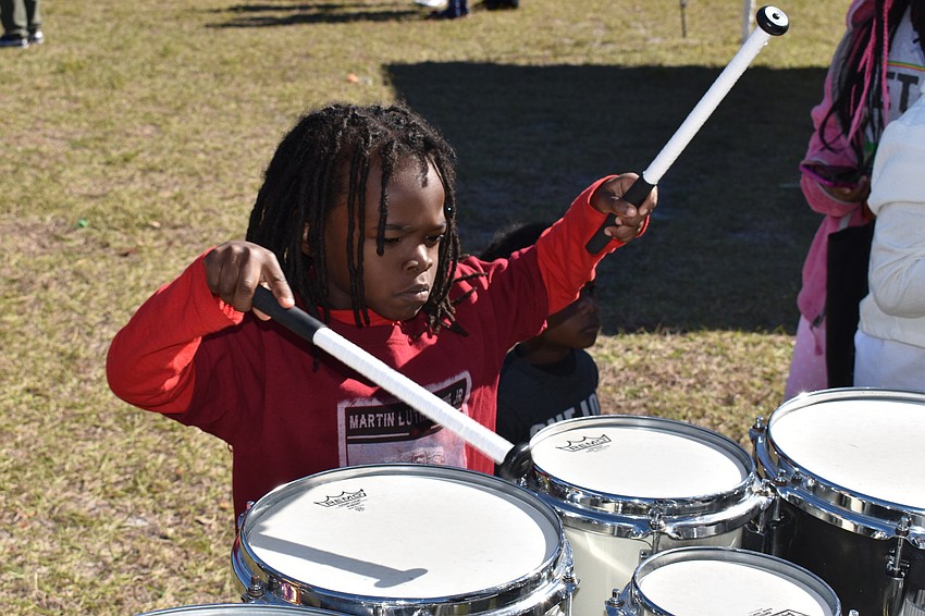 Ahmad Tillery tries out the drums before the march.