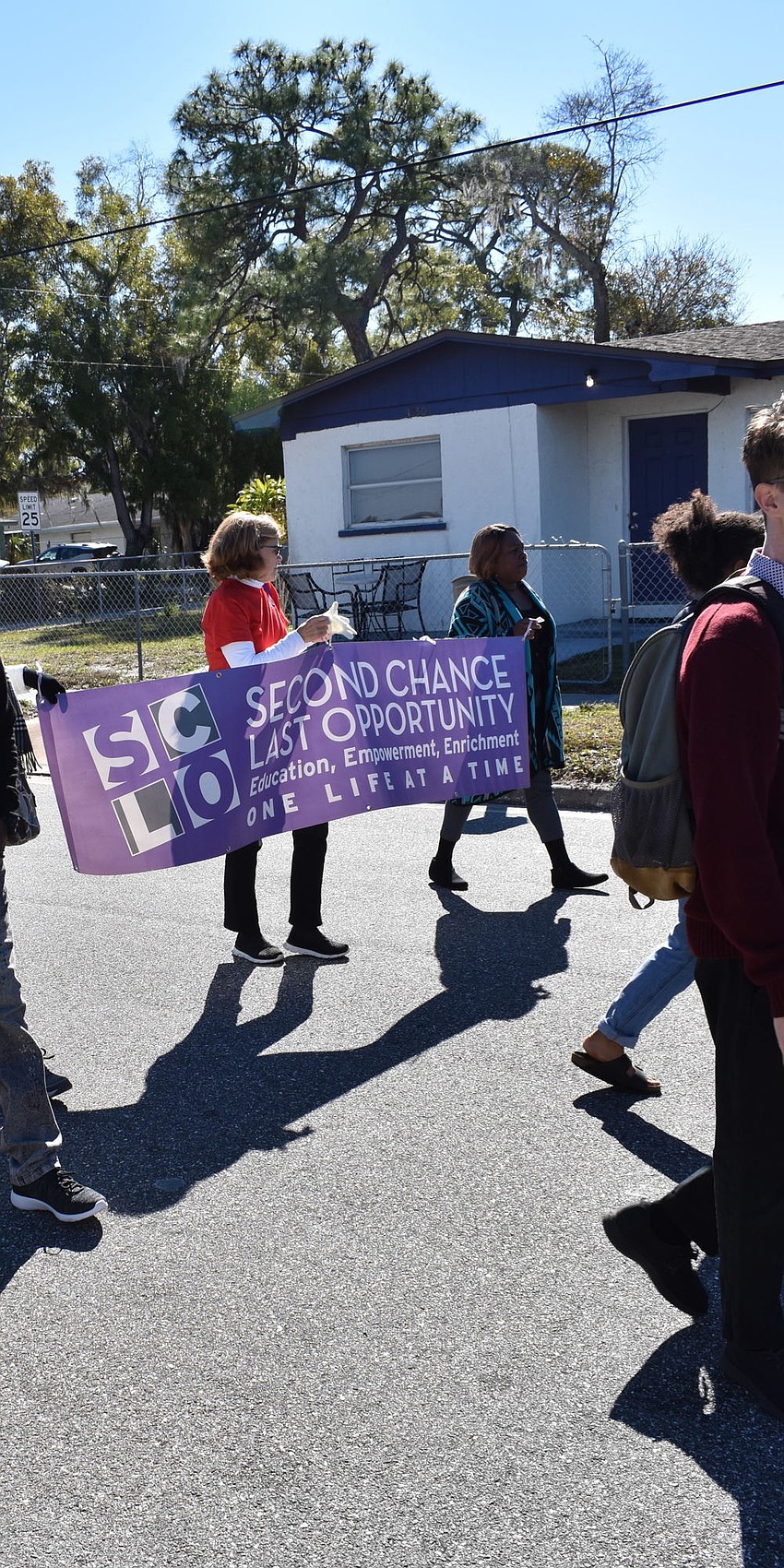 Nina Tortelli and April Glasco march with a sign for Second Chance Last Opportunity. Glasco is the founder of the nonprofit.
