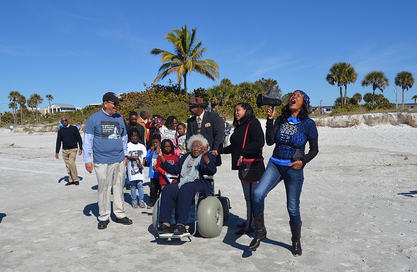 Attendees continued to sing as they moved from the beach pavilion onto the sand.